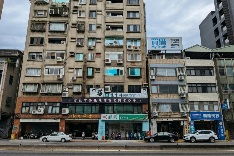 a tall building on the corner of an intersection