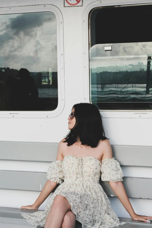 a lady is sitting on the back of a boat