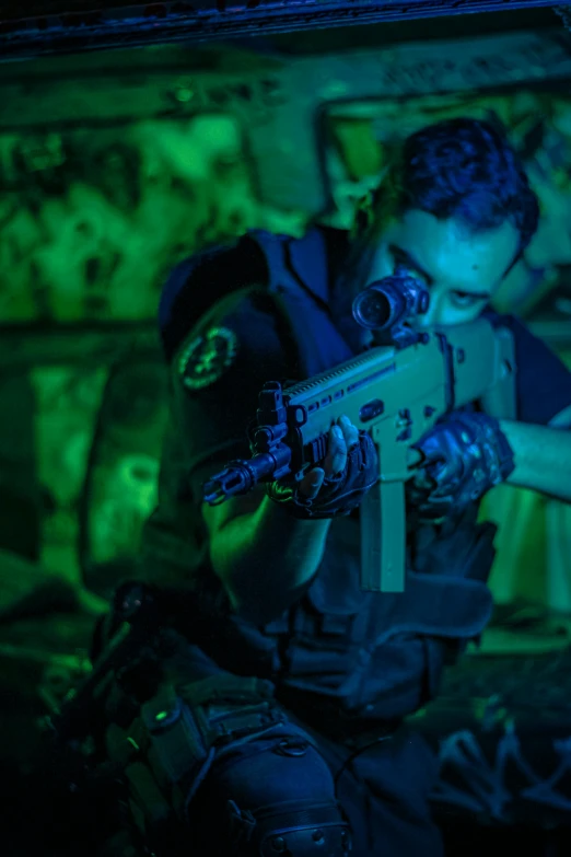 a man is holding a machine gun with a flashlight