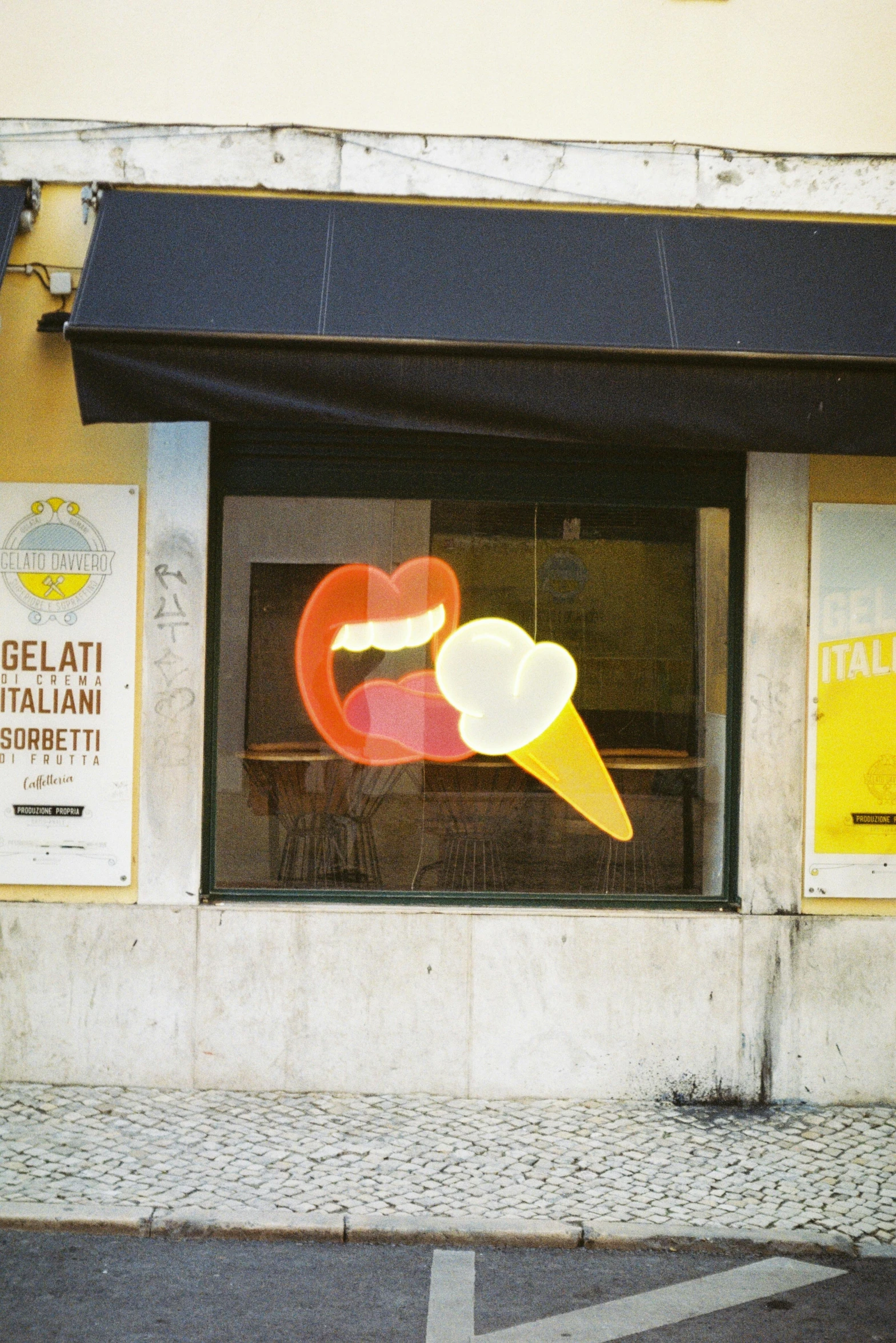 a store window with art work in the reflection