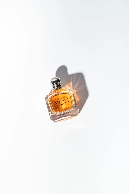 a bottle of u vy perfume against a white background