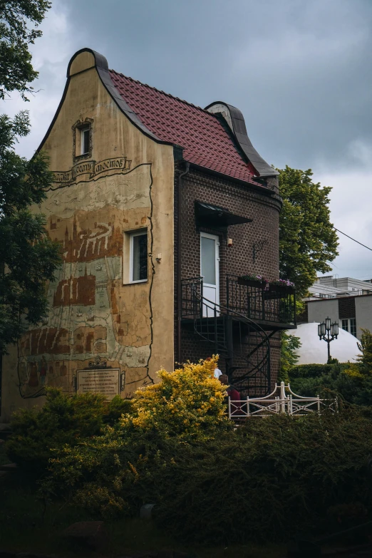 there is a large building with a red roof and brown walls