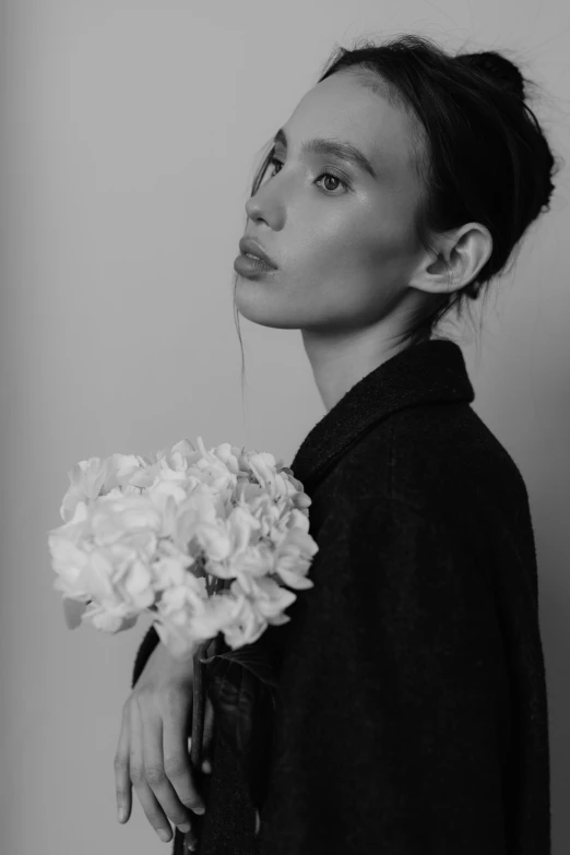 black and white pograph of woman with flowers