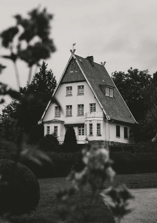 a big house with flowers in front of it