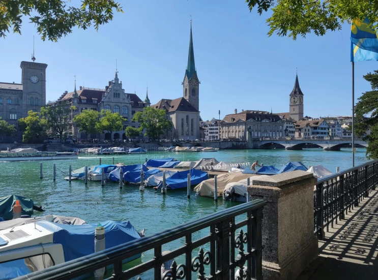 some boats are in the water near many buildings