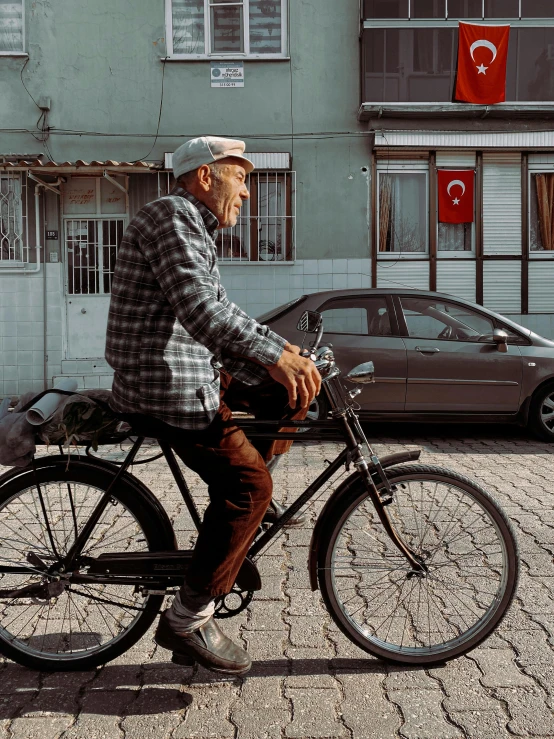 an elderly man rides his bicycle down the street