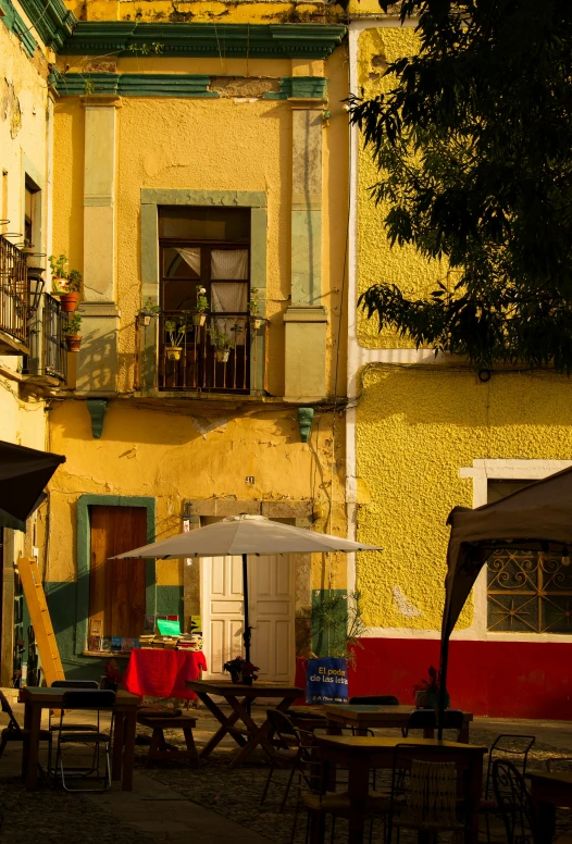 many patio tables sitting on a street corner