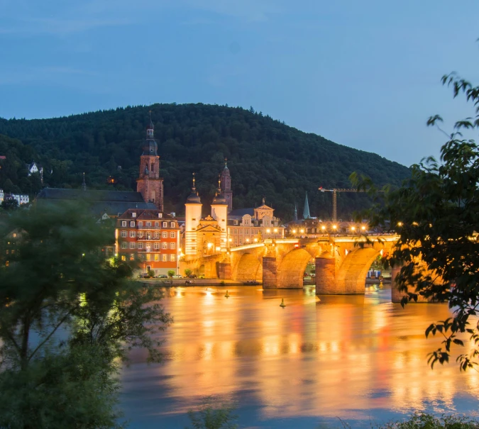 a view of the river in a town at night