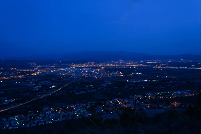 an aerial view of the night sky and town lights