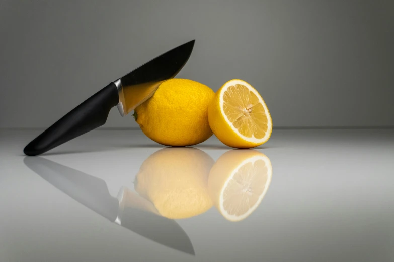 an orange cut into pieces sitting on a reflective surface