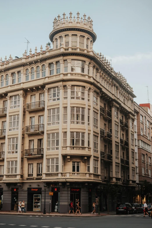 people crossing the street outside an old building