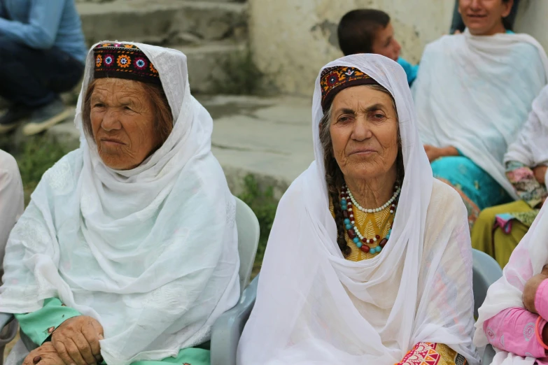 the three women are sitting in a group