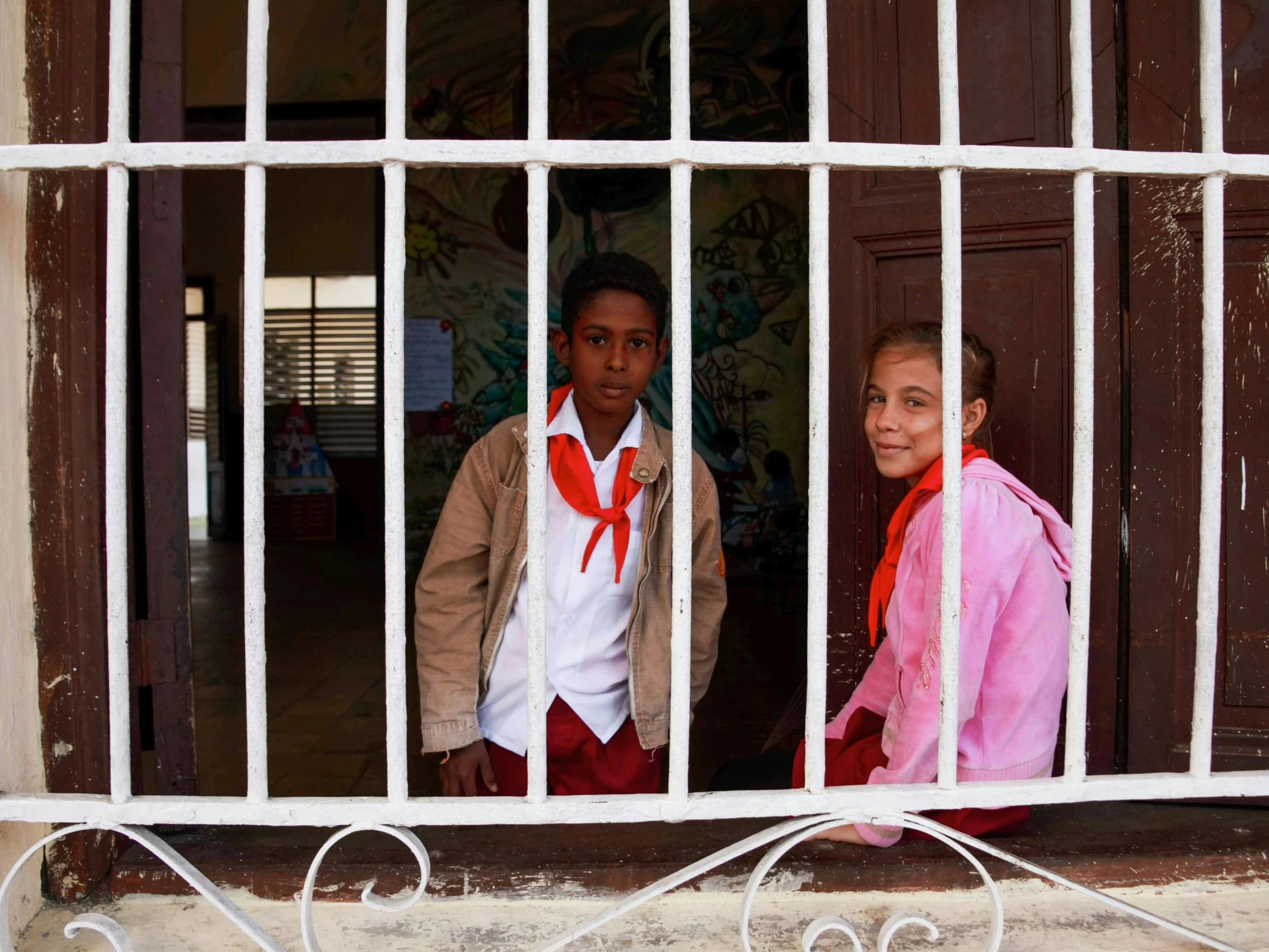 two s that are standing in front of a window