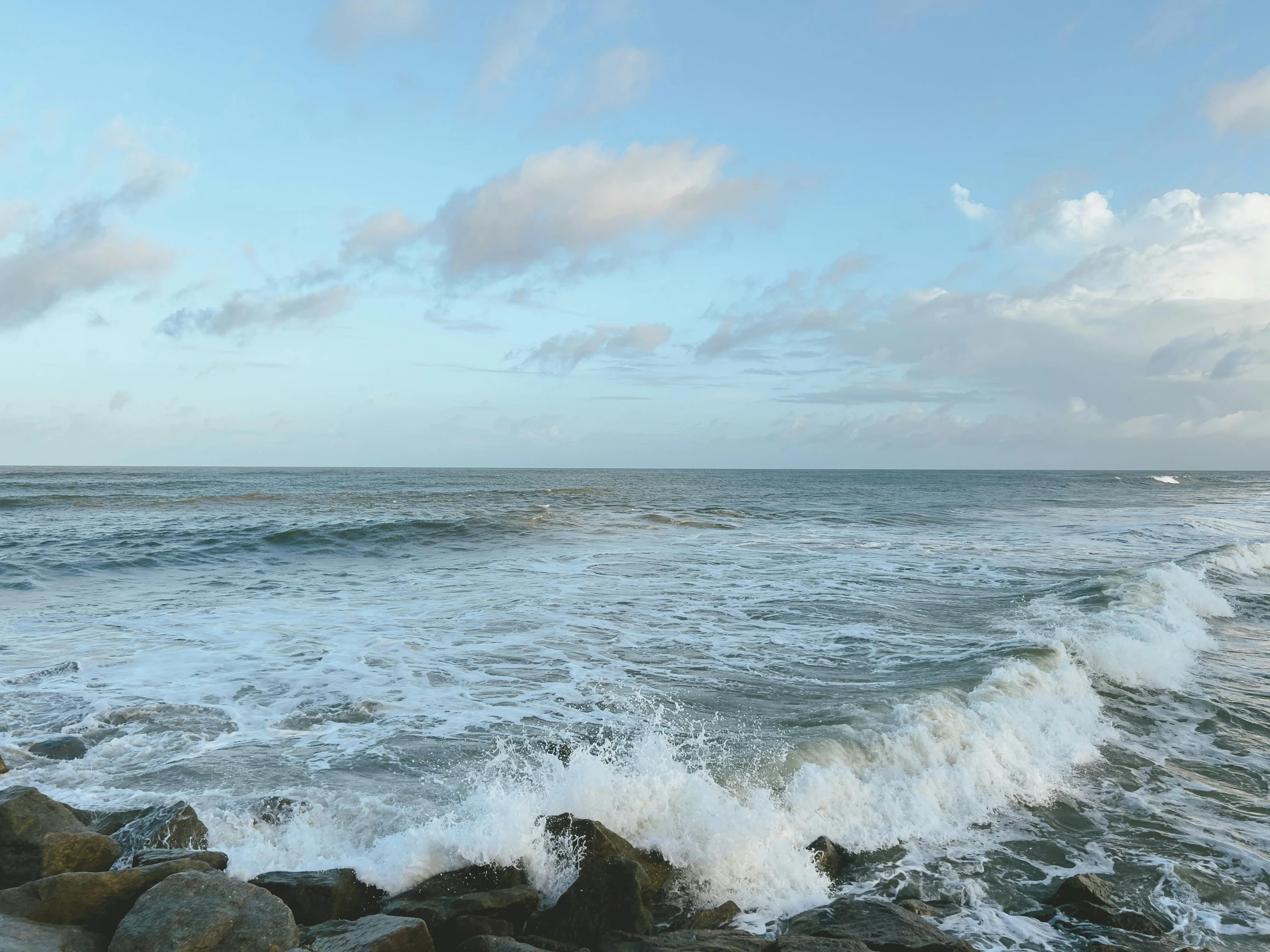 there is a picture of a ocean scene taken from the rocks