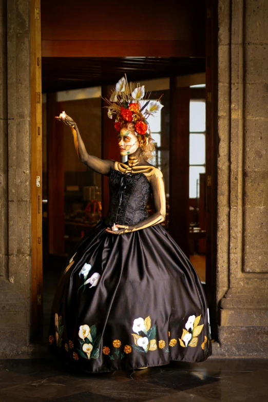 a woman in black dress holding a wand