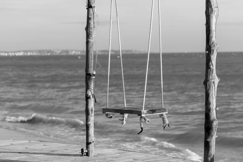 a black and white po of the ocean next to a deck