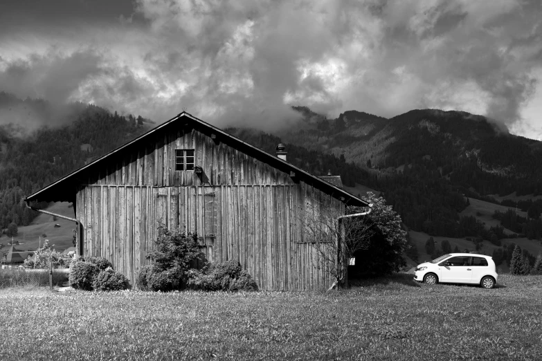 there is a truck that is in front of a barn