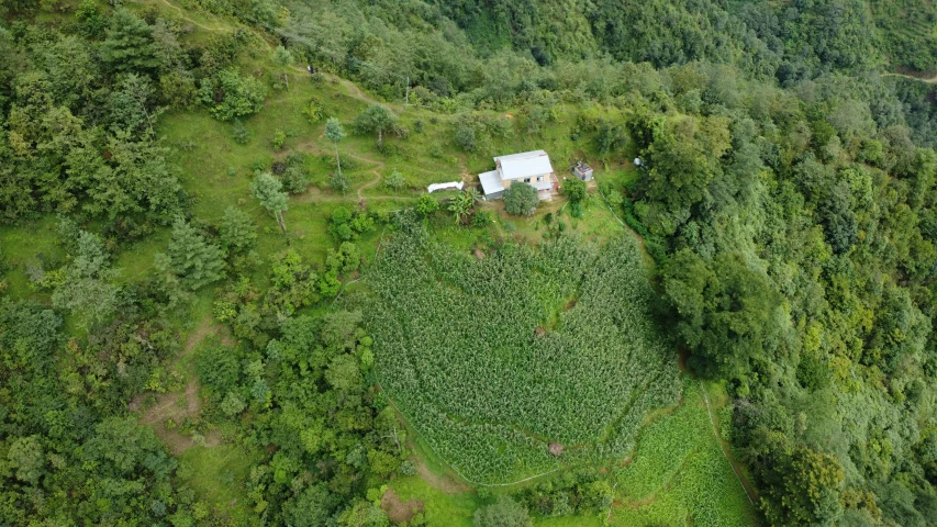 a small house in the middle of a field