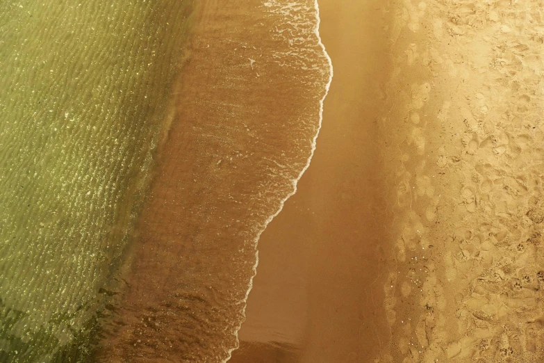 two green water and dirt areas of a beach