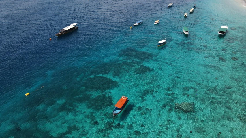 the water is clear and blue with boats on it