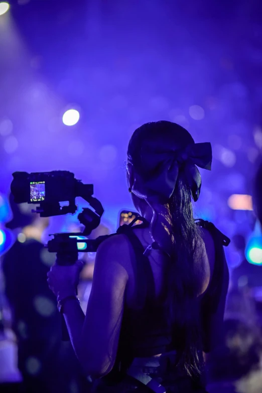 a girl with long hair holding a camera