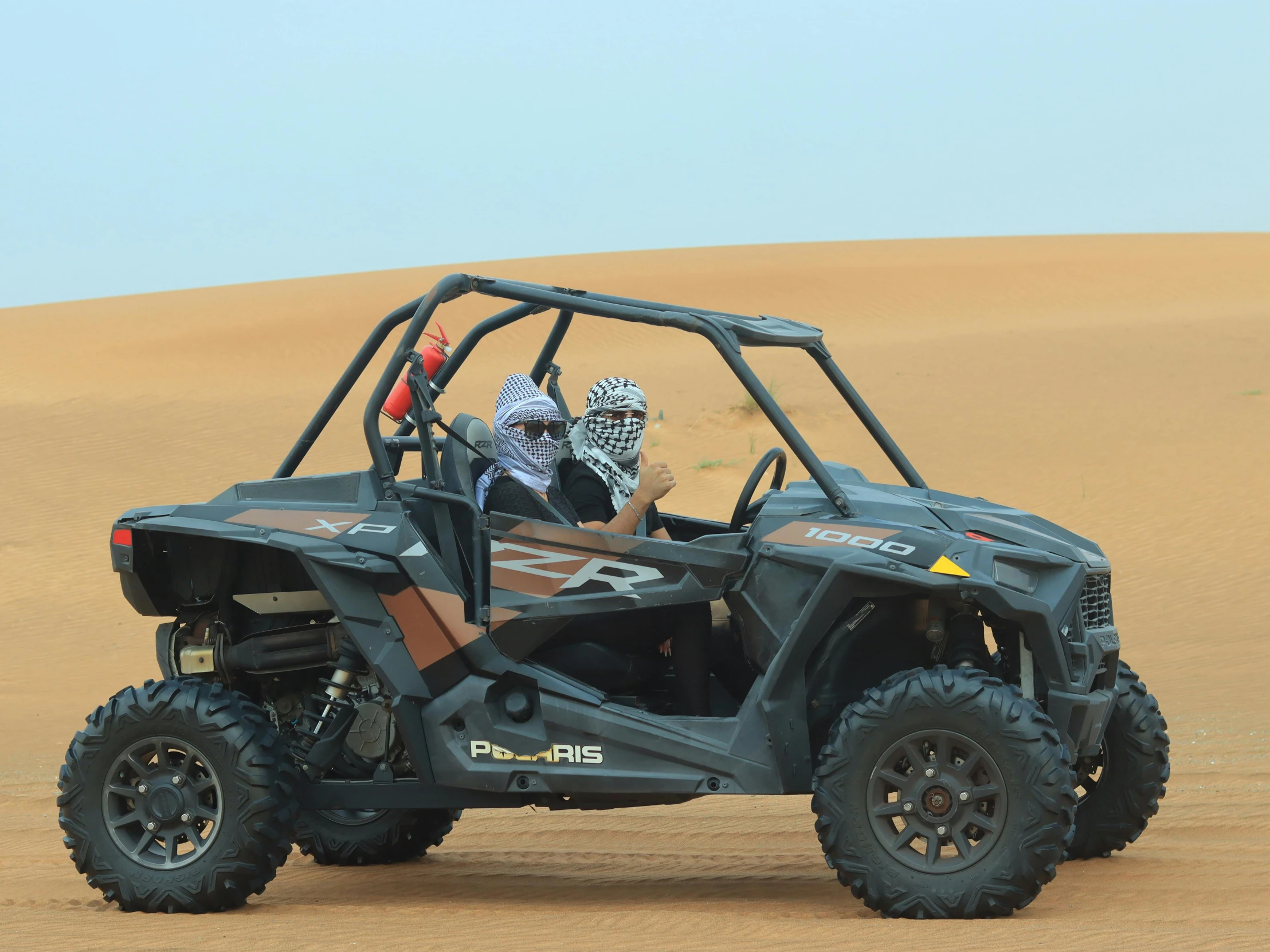 two people riding in a polar bear dune buggy