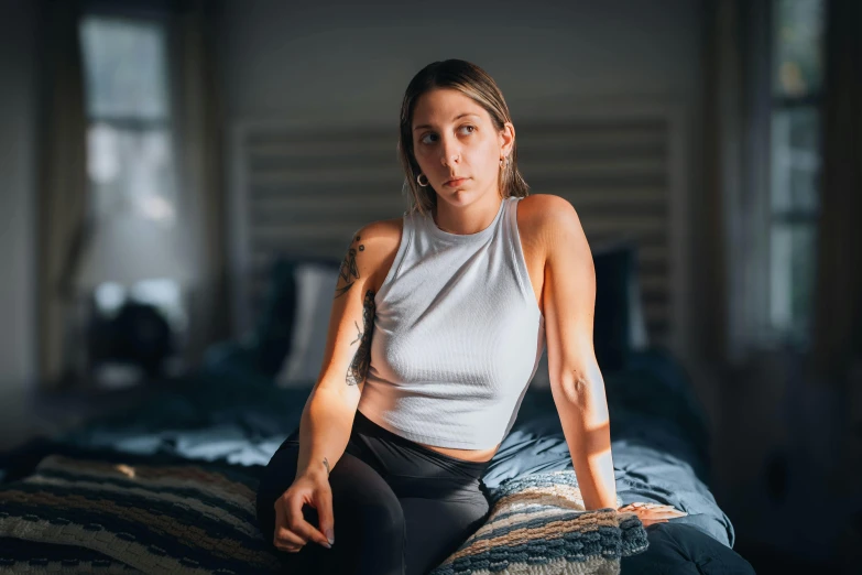 an image of a woman that is sitting down on the bed