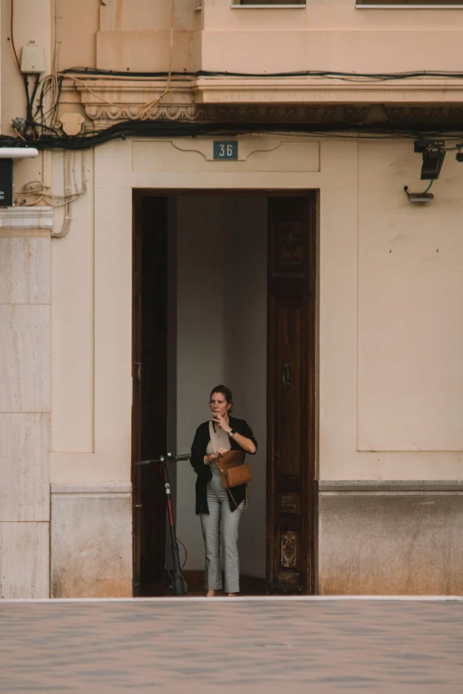 there is a woman that is standing at the door