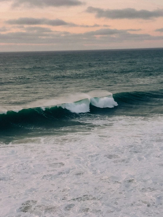 a surfer rides a large wave in the ocean