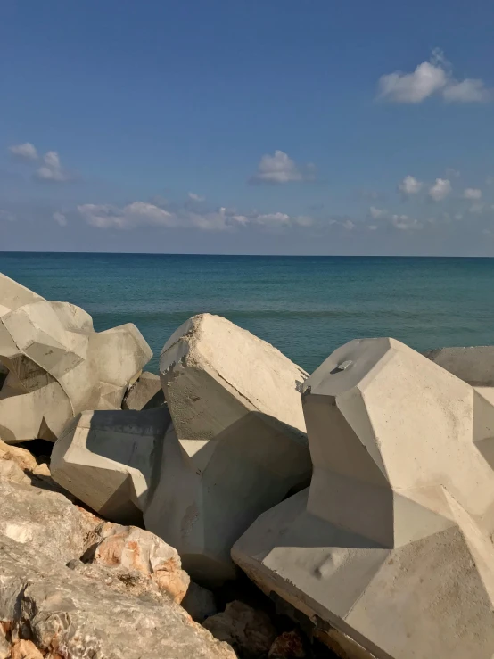 large rocks are shown along the shore near the water