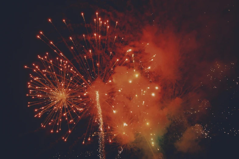 an assortment of fireworks exploding and flying in the air