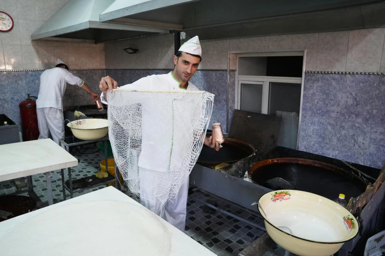 a cook holding a piece of cloth in the kitchen