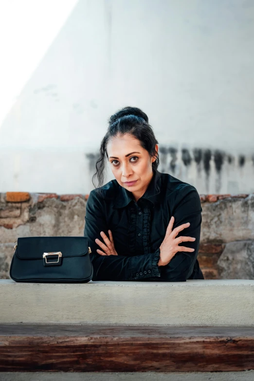 woman sitting at a table with her purse