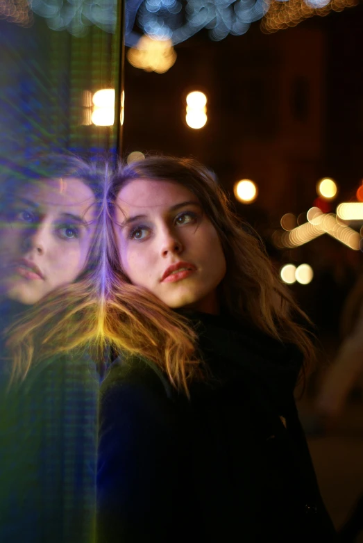 two girls are staring at soing with blurry lights