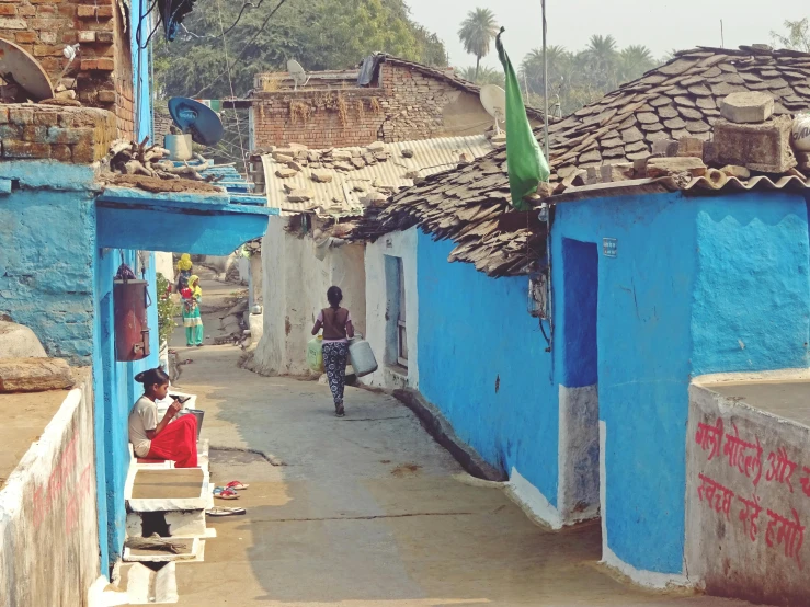 small  on a bike in a blue village