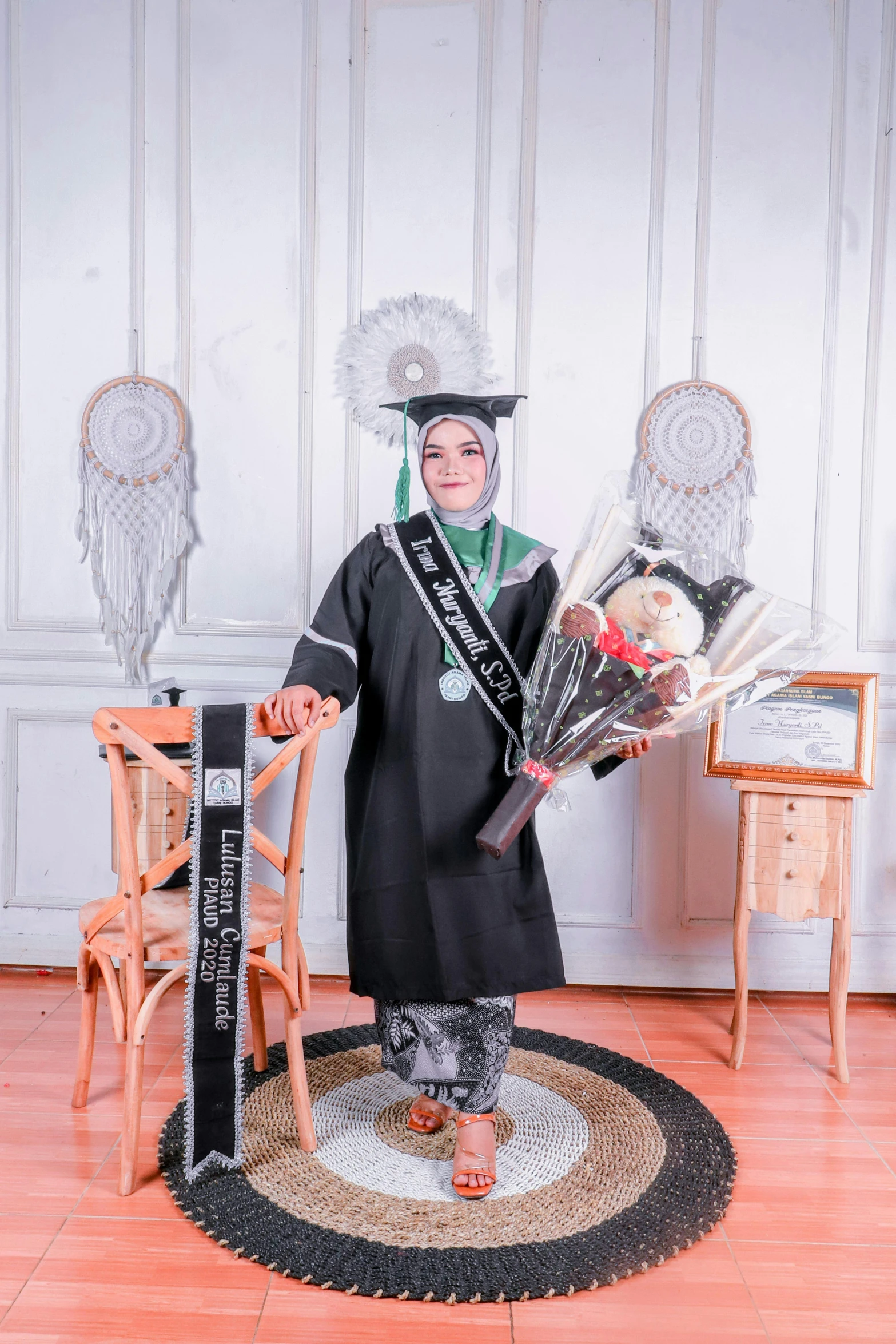 a person wearing a black and white robe is holding flowers