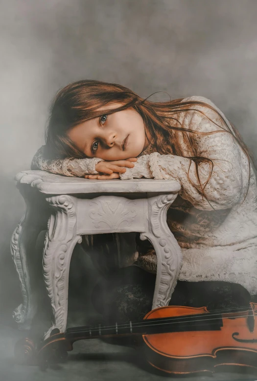 an old po of a  laying on a white table next to a violin