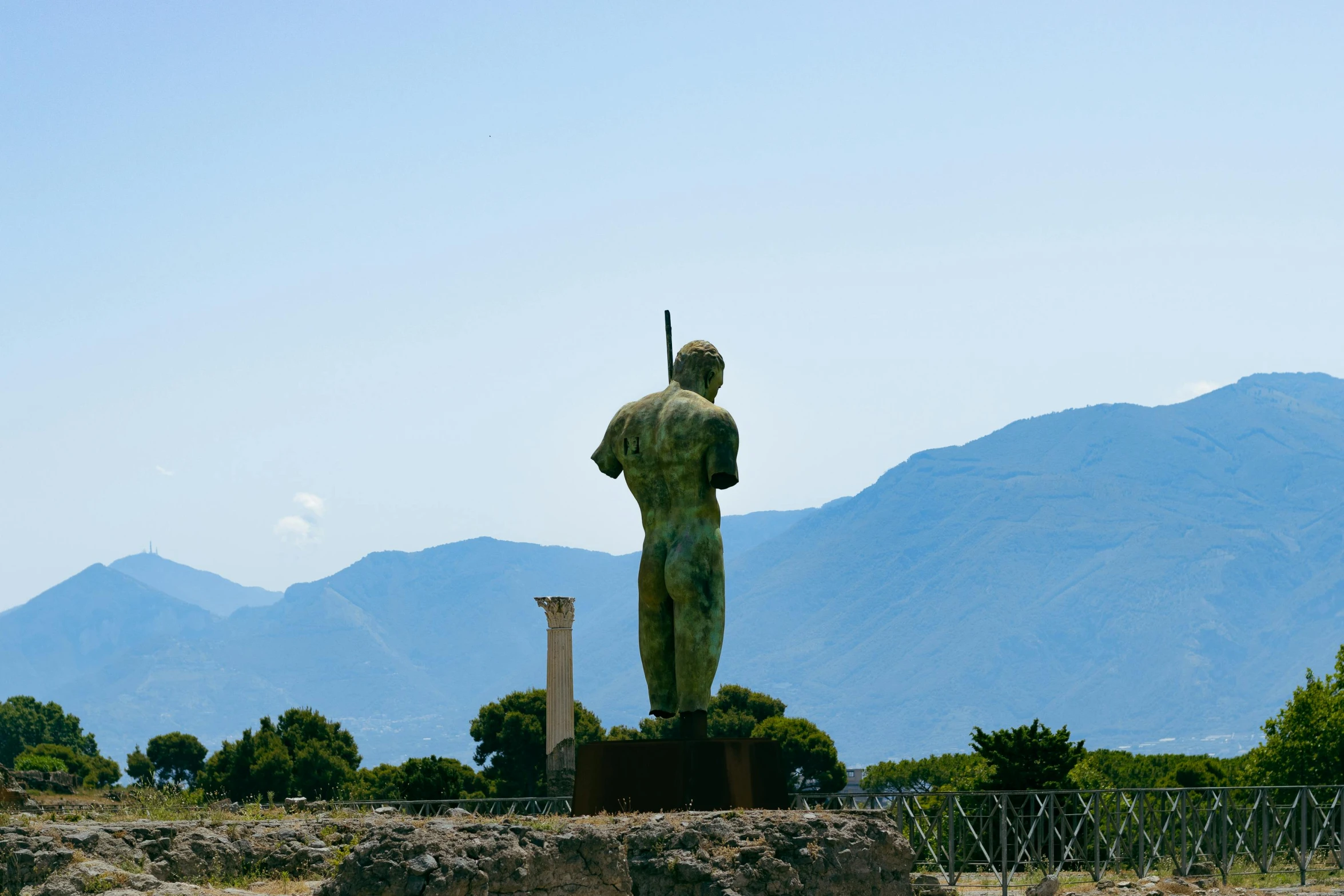 a statue of a man on the top of a hill