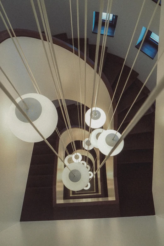 an overhead view shows two rows of tables in a room with white walls and dark wood beams