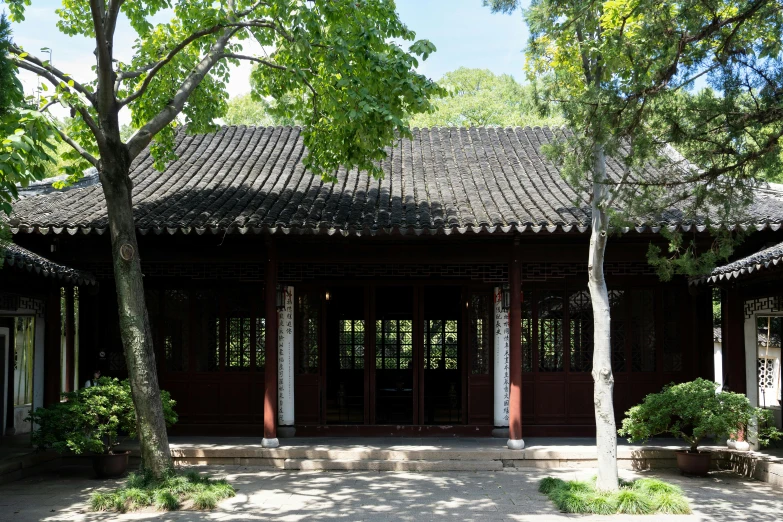 an ornate building in a park area surrounded by trees