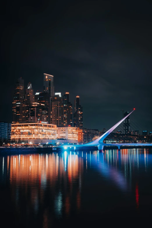 a city skyline with a bridge going over a body of water