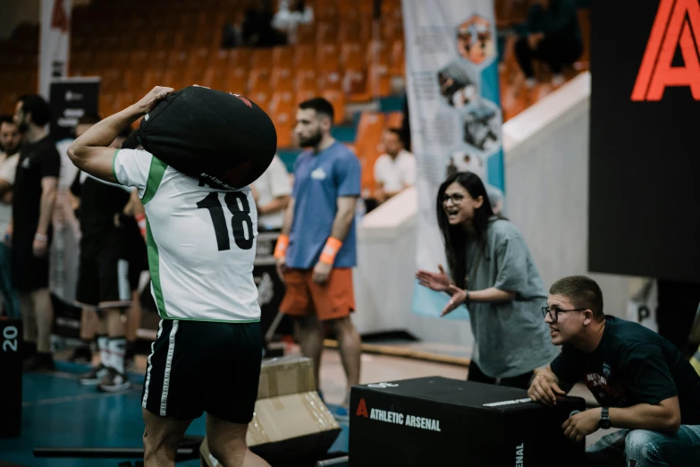 a man on a basketball court with his head above his shoulder