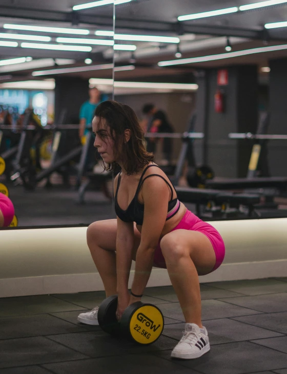 the woman is sitting on the ground with two exercise balls