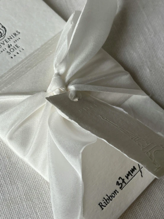 the label on an opened white linen garment