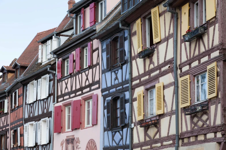 a group of buildings with some different color windows