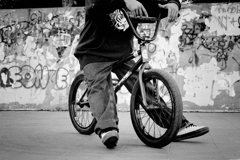 a man that is standing on a bike