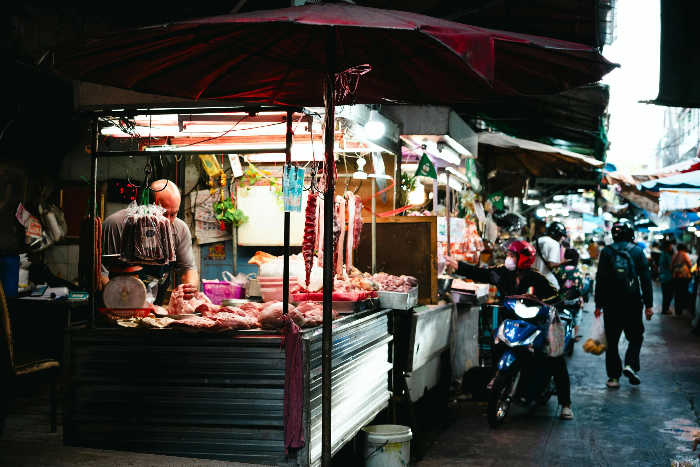 an open air stand with food for sale at an outdoor market