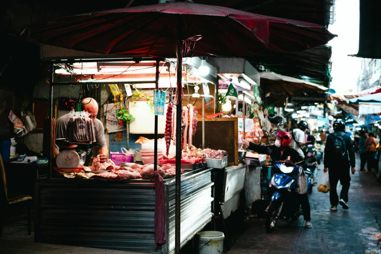 an open air stand with food for sale at an outdoor market