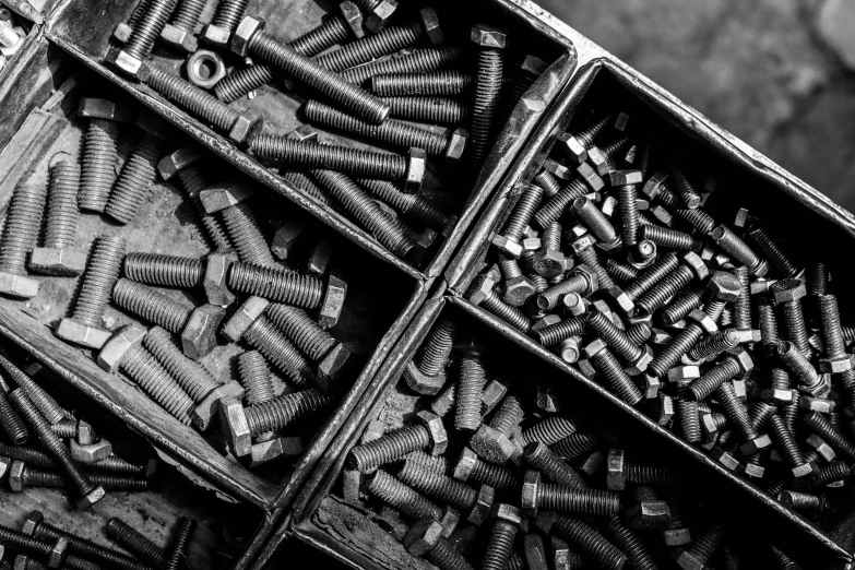 an open box filled with nails and bolts