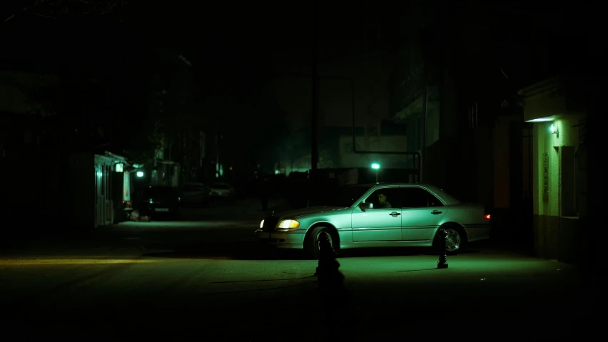 a car parked in front of a dark alley